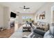 Inviting living room with a fireplace, ceiling fan, and patio access at 10134 E Meandering Trail Ln, Gold Canyon, AZ 85118