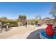 Cozy backyard patio with desert landscaping, seating area and decor; a tranquil desert oasis at 10134 E Meandering Trail Ln, Gold Canyon, AZ 85118