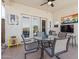 Covered patio with a table set, outdoor decor, and sliding glass doors to inside at 10134 E Meandering Trail Ln, Gold Canyon, AZ 85118
