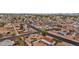 Expansive aerial view showcases a neighborhood with diverse home styles, mature trees, and city skyline views in the distance at 1031 W Cornell Dr, Tempe, AZ 85283