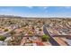 Wide aerial shot showcases a neighborhood with tree coverage, a winding road, and distant mountain views at 1031 W Cornell Dr, Tempe, AZ 85283
