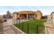 View of fenced backyard featuring a turf lawn, patio and exterior of house at 1031 W Cornell Dr, Tempe, AZ 85283