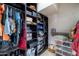 Organized walk-in closet with shelving, rods, and storage for clothes, shoes, and accessories at 1031 W Cornell Dr, Tempe, AZ 85283