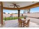 Inviting covered patio with a ceiling fan and a backyard featuring a fountain and artificial grass at 1031 W Cornell Dr, Tempe, AZ 85283