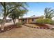 Cozy single-story home with solar panels, xeriscaped landscaping, and a brick walkway to the front door at 1031 W Cornell Dr, Tempe, AZ 85283