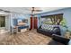 Cozy living room featuring a ceiling fan, wood-look tile floors, and a view of the front yard at 1031 W Cornell Dr, Tempe, AZ 85283