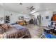 Spacious main bedroom showcasing wood-look flooring, fan, multiple windows, and ample space at 1031 W Cornell Dr, Tempe, AZ 85283