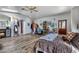 Spacious main bedroom showcasing wood-look flooring, fan, multiple windows, and ample space at 1031 W Cornell Dr, Tempe, AZ 85283