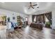 Spacious main bedroom showcasing wood-look flooring, fan, multiple windows, and ample space at 1031 W Cornell Dr, Tempe, AZ 85283