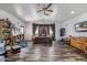 Spacious main bedroom showcasing wood-look flooring, fan, multiple windows, and ample space at 1031 W Cornell Dr, Tempe, AZ 85283