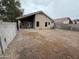 View of home exterior and gravel-filled backyard at 10463 W Medlock Dr, Glendale, AZ 85307