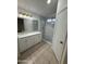Bright renovated bathroom with granite counters, elegant light fixture, and a tiled shower at 10463 W Medlock Dr, Glendale, AZ 85307