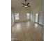 Bright neutral bedroom features tile flooring, two windows, and a french door at 10463 W Medlock Dr, Glendale, AZ 85307