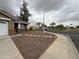Single-story house with brown gravel landscaping and shade tree at 10463 W Medlock Dr, Glendale, AZ 85307