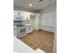 Modern kitchen featuring white cabinets, stainless steel appliances, and ceramic tile flooring at 10463 W Medlock Dr, Glendale, AZ 85307
