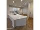 Bright, updated kitchen with white cabinets, quartz countertops, and stainless steel appliances at 10463 W Medlock Dr, Glendale, AZ 85307