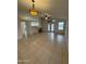 Bright living room boasts tile floors, natural light, and a modern ceiling fan at 10463 W Medlock Dr, Glendale, AZ 85307