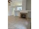 Open living room with fireplace and tile floors at 10463 W Medlock Dr, Glendale, AZ 85307