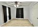 Bedroom with wood-look flooring, ceiling fan, and two windows with dark curtains at 11613 N 21St Ave, Phoenix, AZ 85029