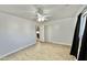 Bright bedroom with ceiling fan, laminate flooring, neutral paint, and sliding closet doors at 11613 N 21St Ave, Phoenix, AZ 85029