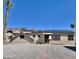 Charming single-story home with desert landscaping and modern solar panels, set against a clear blue sky at 11613 N 21St Ave, Phoenix, AZ 85029