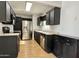 Kitchen with wood-look floors, stainless steel appliances, dark cabinets and light countertops at 11613 N 21St Ave, Phoenix, AZ 85029