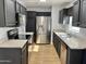 Well-lit kitchen featuring stainless steel appliances, dark cabinetry, and light countertops at 11613 N 21St Ave, Phoenix, AZ 85029