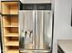 Close-up of stainless steel refrigerator with water dispenser, and dark cabinets with wood interiors at 11613 N 21St Ave, Phoenix, AZ 85029