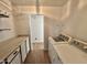 Functional laundry room with appliances, cabinets, countertops, shelving, and views into the next room at 11613 N 21St Ave, Phoenix, AZ 85029