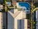 Birds eye view of a well-maintained home featuring a pristine pool, green space, and outdoor living area at 12531 W Tuckey Ln, Glendale, AZ 85307