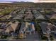Aerial perspective of a residential neighborhood with lovely houses, pools, and manicured green spaces at 12531 W Tuckey Ln, Glendale, AZ 85307