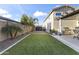 Well-maintained backyard features a large lawn, mature trees, and tasteful patio area for relaxation at 12531 W Tuckey Ln, Glendale, AZ 85307