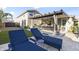 Expansive backyard with a lounge chairs, covered patio, and dining area, perfect for entertaining at 12531 W Tuckey Ln, Glendale, AZ 85307