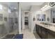 The main bathroom features a glass enclosed shower, double vanity with granite counters, and walk-in closet at 12531 W Tuckey Ln, Glendale, AZ 85307