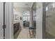 A primary bathroom leads to the walk-in shower and main bedroom through a short hallway at 12531 W Tuckey Ln, Glendale, AZ 85307