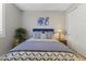 Cozy bedroom features a blue headboard, stylish bedding, and tasteful decor for a relaxing ambiance at 12531 W Tuckey Ln, Glendale, AZ 85307