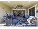 Relaxing covered patio featuring comfortable seating, ceiling fan, and view of the backyard at 12531 W Tuckey Ln, Glendale, AZ 85307