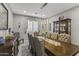 Sophisticated dining area featuring a long, wooden table, comfortable chairs, and elegant window treatments at 12531 W Tuckey Ln, Glendale, AZ 85307