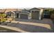 Stunning single-Gathering home showcasing a spacious three-car garage and a paved driveway at 12531 W Tuckey Ln, Glendale, AZ 85307