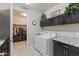 Convenient laundry room with walk in closet and modern washer and dryer, dark cabinets at 12531 W Tuckey Ln, Glendale, AZ 85307