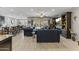 Expansive living area with tile flooring, comfortable blue sofas, and access to the backyard at 12531 W Tuckey Ln, Glendale, AZ 85307