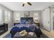 A comfortable main bedroom features a large bed with bedside tables, plantation shutters, and decorative furnishings at 12531 W Tuckey Ln, Glendale, AZ 85307