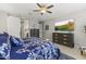 A main bedroom showcases a TV above a dresser, a ceiling fan, and an attached bathroom with sliding barn door at 12531 W Tuckey Ln, Glendale, AZ 85307