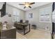 Well-lit office with modern desk, shutters, and wood-look tile flooring at 12531 W Tuckey Ln, Glendale, AZ 85307