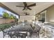 Covered patio with an outdoor kitchen and an iron table with seating for many at 12531 W Tuckey Ln, Glendale, AZ 85307