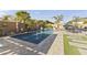 A backyard pool features lush landscaping, a built-in barbecue, and ample space for outdoor entertaining at 12531 W Tuckey Ln, Glendale, AZ 85307