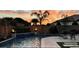 Backyard view of a relaxing pool and patio with luxury outdoor furniture at sunset at 12531 W Tuckey Ln, Glendale, AZ 85307