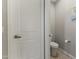 The powder room features a toilet and neutral paint with tiled flooring at 12531 W Tuckey Ln, Glendale, AZ 85307
