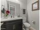 Chic powder room featuring a modern vanity, decorative accents, and a stylish mirror at 12531 W Tuckey Ln, Glendale, AZ 85307