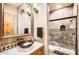 Modern bathroom featuring vanity with a bowl sink, large mirror, and step-in shower at 1523 N 103Rd St, Mesa, AZ 85207